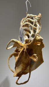 Hanging Cage, 2023, carborundum prints on paper formed over paper clay, plastic, metal, pigments, 26 x 14 x 12 inches