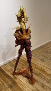 Manic-cureist, 2023, paper, wool, plastic, metal, wood, crushed glass, mirrors, and pigments