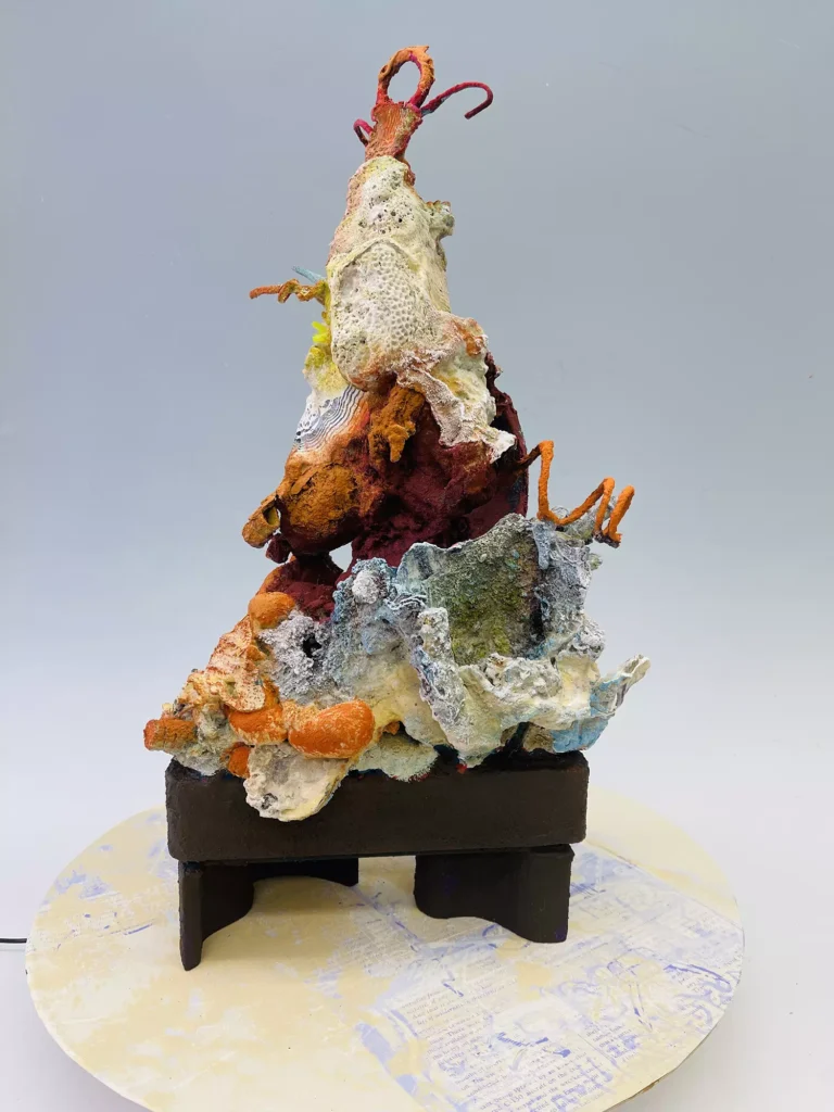 AS THE WORLD TURNS, 2026, serigraph and collagraph prints on paper, wood, plastic, 25 x 20 x 20